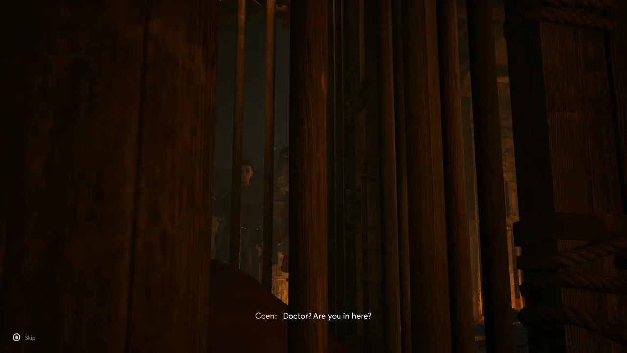 Coen calls for the doctor behind wooden beams. This scene does not identify the exterior entrance.