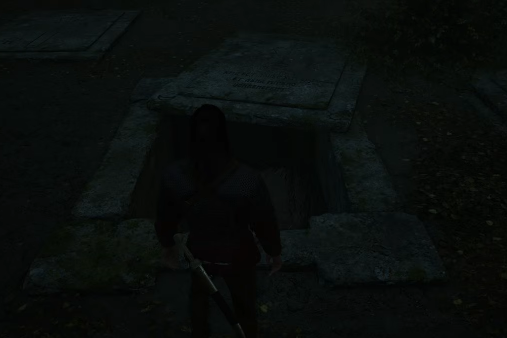 Opened grave entrance; the dark close-up does not show the surrounding grave layout.